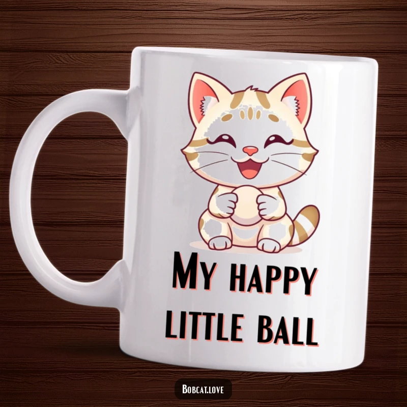 Funny bobcat with a huge, happy grin, delightedly holding a small ball, featured on a ceramic mug.