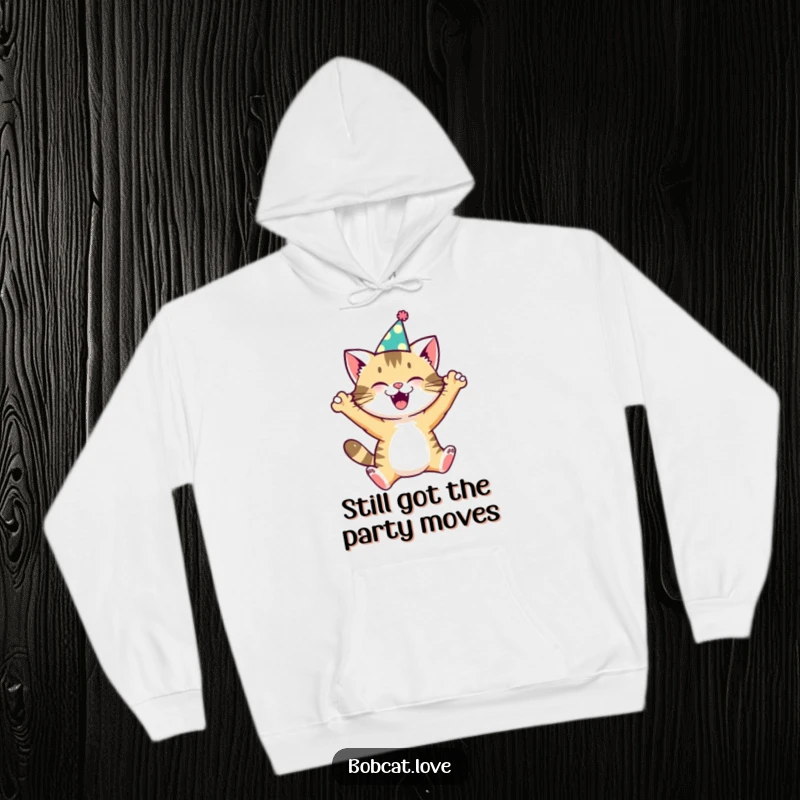 Funny bobcat in a miniature party hat, joyfully leaping, emblazoned on a comfortable hoodie, a perfect funny gift.